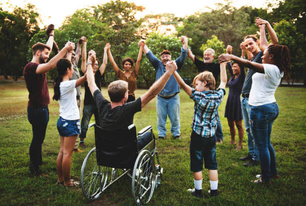 A group of people gathered around a person using a wheelchair